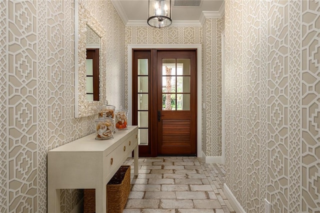40 White Orchid Way, Vero Beach, FL 32963 - doorway featuring crown molding, wallpapered walls, brick floors, and baseboards