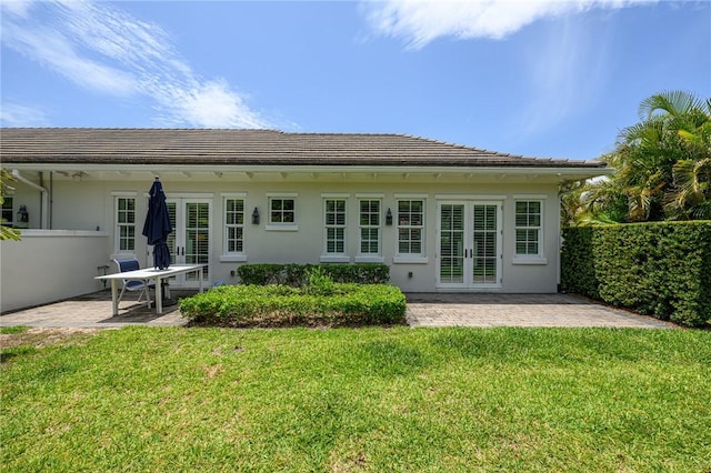 40 White Orchid Way, Vero Beach, FL 32963 - rear view of house featuring french doors, a patio, a yard, and stucco siding