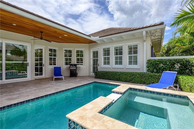 40 White Orchid Way, Vero Beach, FL 32963 - back of property featuring a patio, stucco siding, an outdoor pool, a ceiling fan, and an in-ground hot tub