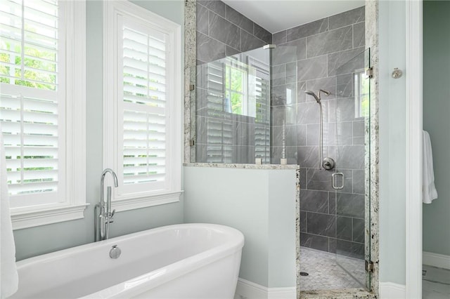 40 White Orchid Way, Vero Beach, FL 32963 - full bath featuring a stall shower, a freestanding tub, and baseboards