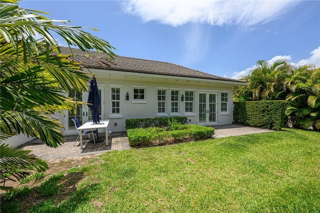40 White Orchid Way, Vero Beach, FL 32963 - rear view of house featuring french doors, a patio area, a yard, and stucco siding