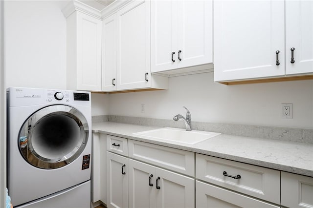 40 White Orchid Way, Vero Beach, FL 32963 - clothes washing area featuring washer / clothes dryer and cabinet space