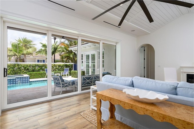 40 White Orchid Way, Vero Beach, FL 32963 - living area with a ceiling fan, arched walkways, light wood-type flooring, and wooden ceiling