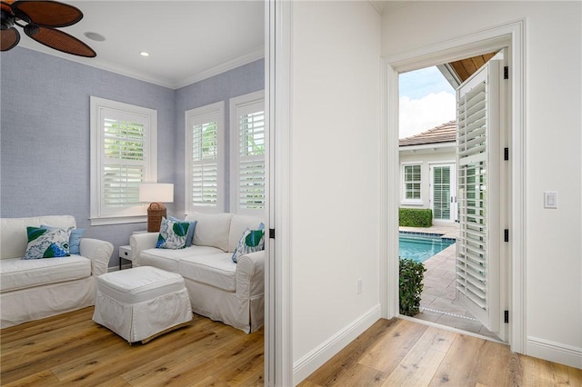 40 White Orchid Way, Vero Beach, FL 32963 - living area featuring light wood-style flooring, a ceiling fan, crown molding, and baseboards