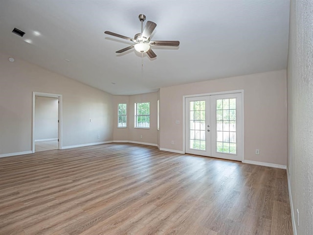 unfurnished room featuring vaulted ceiling, ceiling fan, light wood-type flooring, and french doors