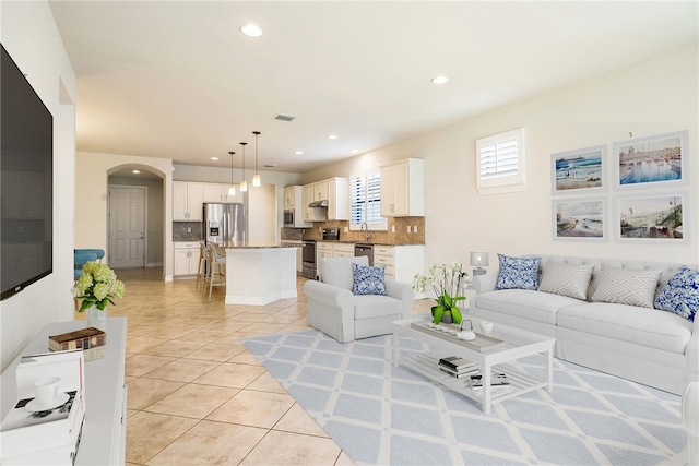 living room with sink and light tile patterned floors