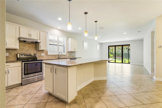 kitchen with light stone countertops, hanging light fixtures, a kitchen island, stainless steel electric range, and white cabinets