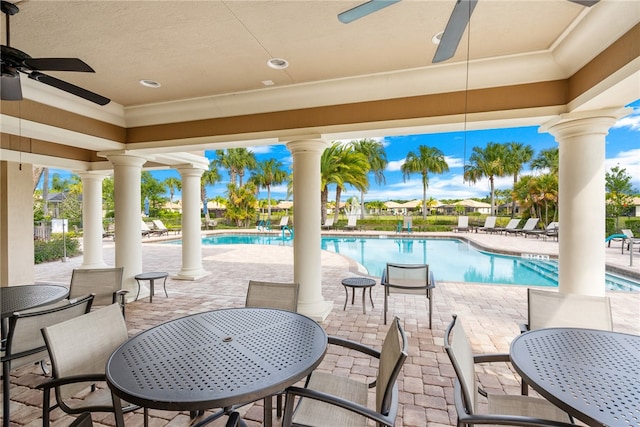 view of patio with ceiling fan and a community pool