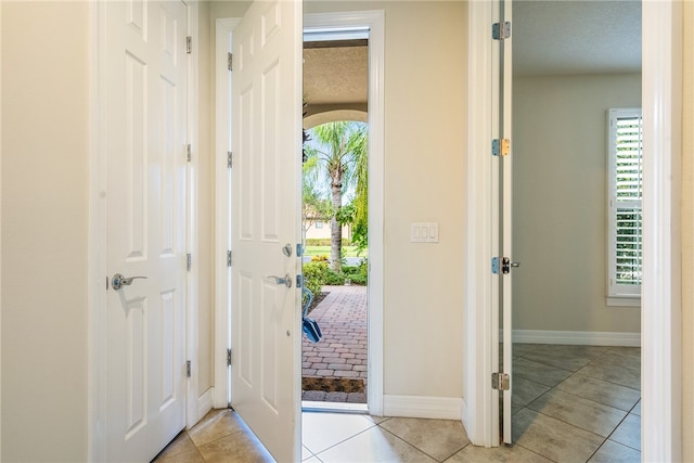 tiled entrance foyer with a wealth of natural light and a textured ceiling