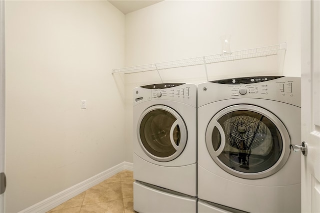 laundry area with light tile patterned floors and separate washer and dryer