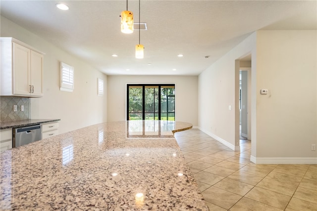 kitchen featuring white cabinetry, dishwasher, light stone counters, backsplash, and pendant lighting