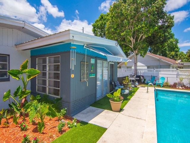exterior space featuring a fenced in pool and fence