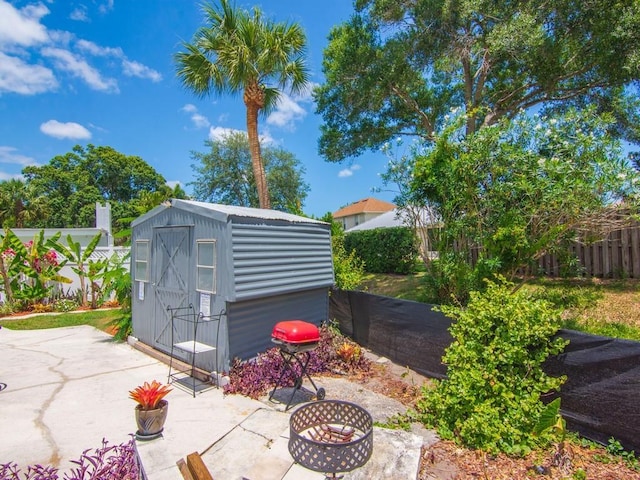 view of shed featuring fence