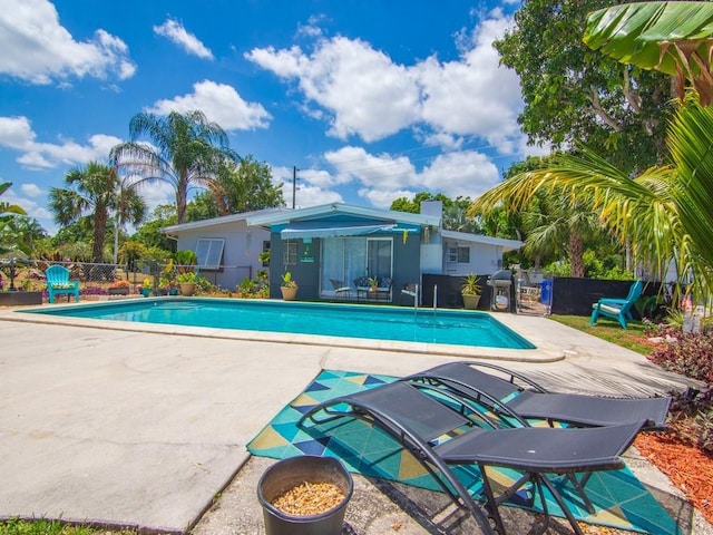 view of pool featuring fence, a fenced in pool, and a patio