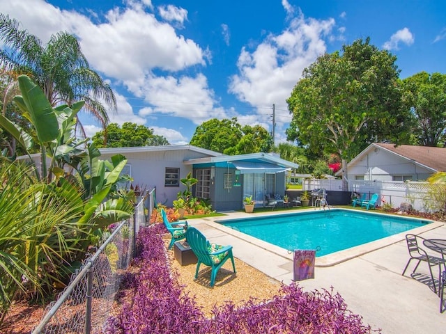 view of pool with a patio, fence, and a fenced in pool