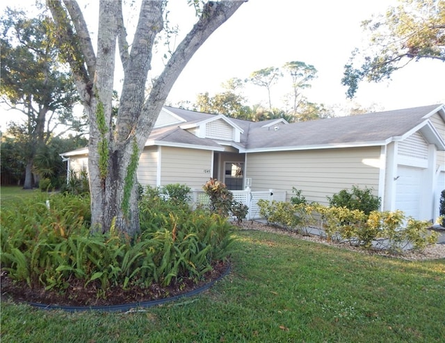 single story home with a front yard and a garage