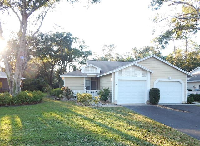 ranch-style house featuring a front yard and a garage