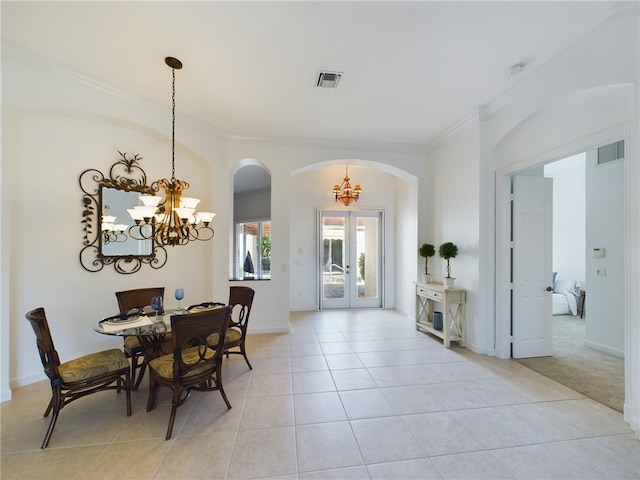 dining room featuring visible vents, ornamental molding, a notable chandelier, and french doors