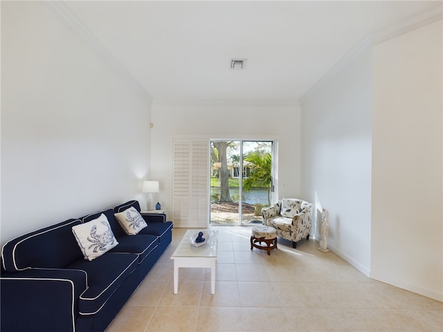 living room with ornamental molding, visible vents, baseboards, and light tile patterned floors