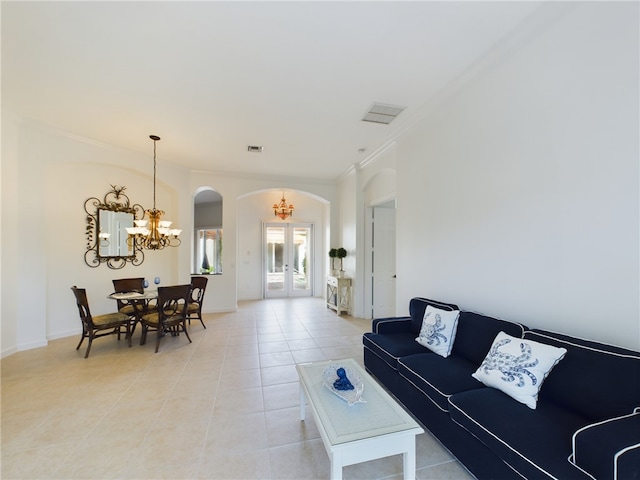 living room featuring a chandelier, light tile patterned floors, arched walkways, french doors, and ornamental molding