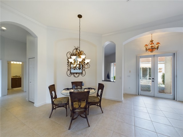 dining area featuring an inviting chandelier, light tile patterned floors, and crown molding