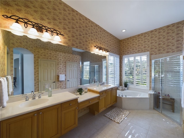 full bathroom with wallpapered walls, a shower stall, a bath, and vanity