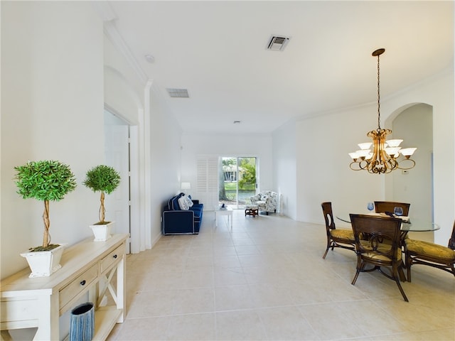 dining area with visible vents, crown molding, and an inviting chandelier