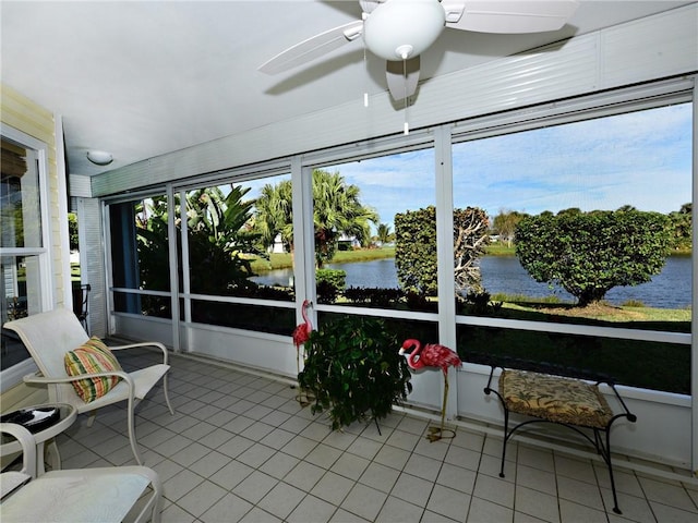 sunroom / solarium featuring a water view and ceiling fan