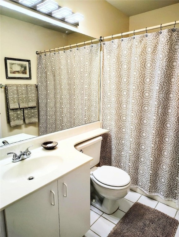 bathroom with vanity, tile patterned floors, and toilet