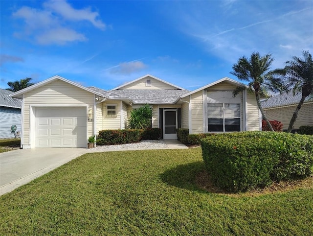 ranch-style house featuring a garage and a front yard