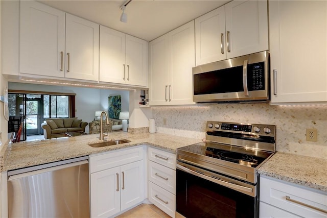 kitchen with sink, track lighting, white cabinetry, and appliances with stainless steel finishes