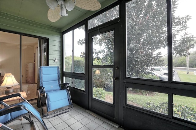 sunroom featuring ceiling fan and a wealth of natural light