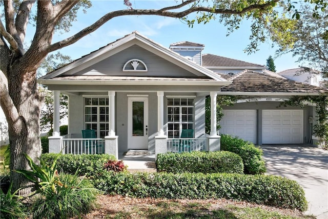 view of front of house featuring a garage and a porch