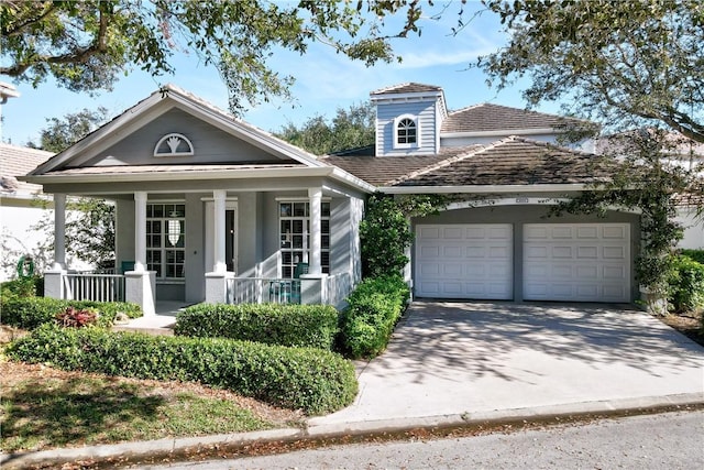 view of front of home with covered porch and a garage