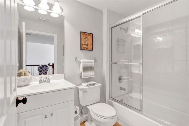 full bathroom with vanity, toilet, and enclosed tub / shower combo