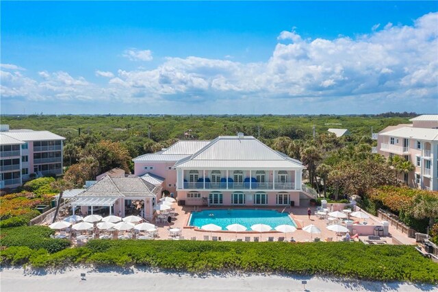 8850 E Orchid Island Cir, Vero Beach, FL 32963 - back of house with an outdoor pool, a patio, a pergola, and a balcony