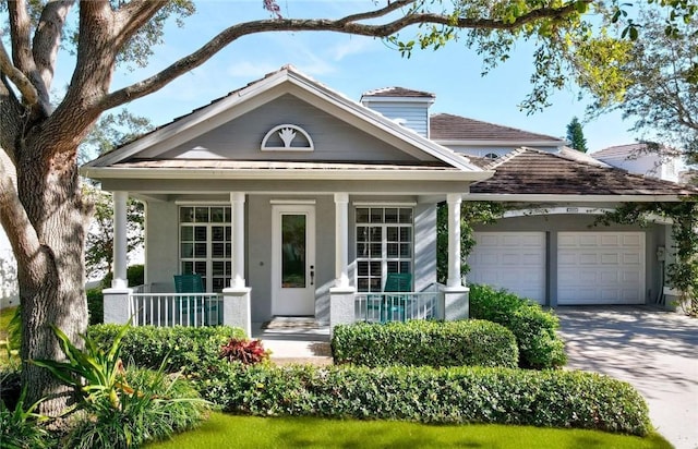 8850 E Orchid Island Cir, Vero Beach, FL 32963 - view of front facade featuring a porch, concrete driveway, a garage, and stucco siding