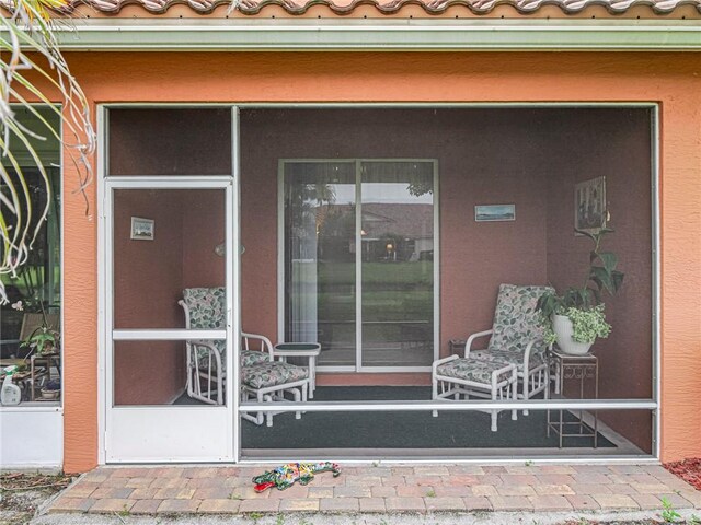 6480 Oxford Cir Unit 103C, Vero Beach, FL 32966 - view of exterior entry with a tiled roof and stucco siding