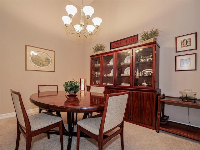6480 Oxford Cir Unit 103C, Vero Beach, FL 32966 - dining space with light carpet, a chandelier, and baseboards