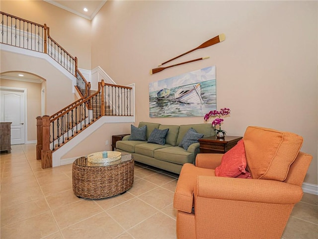 4570 Bridgepointe Way Unit 148, Vero Beach, FL 32967 - living room with arched walkways, light tile patterned floors, a towering ceiling, ornamental molding, and stairs