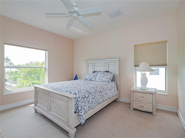 4570 Bridgepointe Way Unit 148, Vero Beach, FL 32967 - bedroom with light carpet, multiple windows, and a ceiling fan