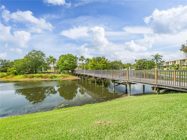 4570 Bridgepointe Way Unit 148, Vero Beach, FL 32967 - dock with a water view and a yard