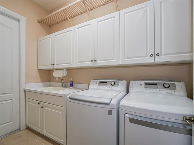 4570 Bridgepointe Way Unit 148, Vero Beach, FL 32967 - washroom featuring cabinet space, washing machine and clothes dryer, and light tile patterned floors