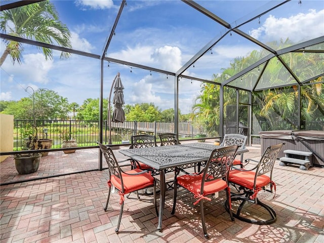 4570 Bridgepointe Way Unit 148, Vero Beach, FL 32967 - view of patio / terrace with a hot tub, glass enclosure, and outdoor dining space