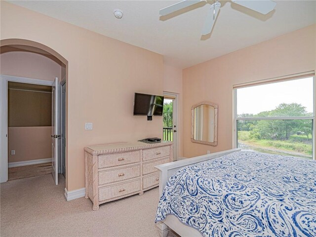 4570 Bridgepointe Way Unit 148, Vero Beach, FL 32967 - bedroom with light colored carpet, arched walkways, and a ceiling fan