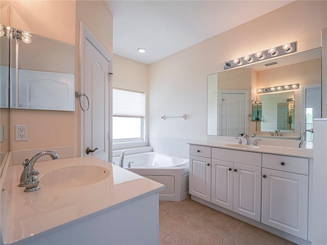 4570 Bridgepointe Way Unit 148, Vero Beach, FL 32967 - full bath with two vanities, a garden tub, tile patterned flooring, and recessed lighting
