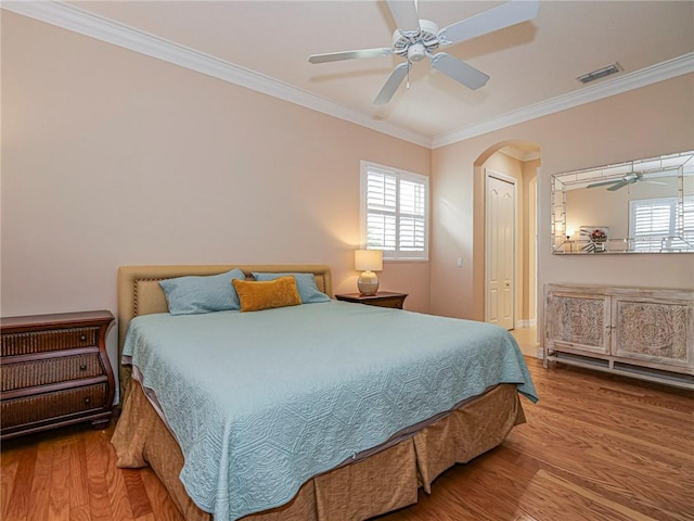 4570 Bridgepointe Way Unit 148, Vero Beach, FL 32967 - bedroom with wood finished floors, multiple windows, crown molding, and arched walkways
