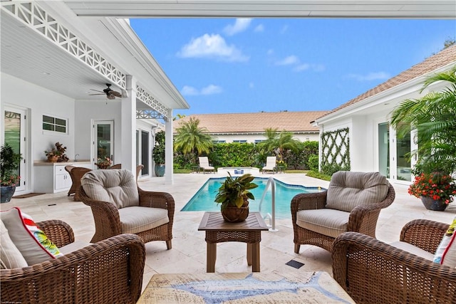 view of swimming pool with exterior kitchen, a patio, and ceiling fan