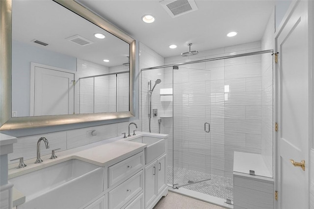 976 25th St, Vero Beach, FL 32960 - full bathroom with a stall shower, double vanity, recessed lighting, decorative backsplash, and tile walls