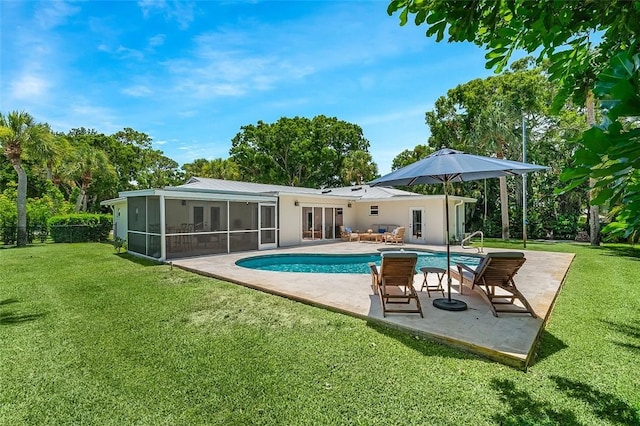 976 25th St, Vero Beach, FL 32960 - back of property with french doors, a sunroom, a patio area, an outdoor pool, and a lawn